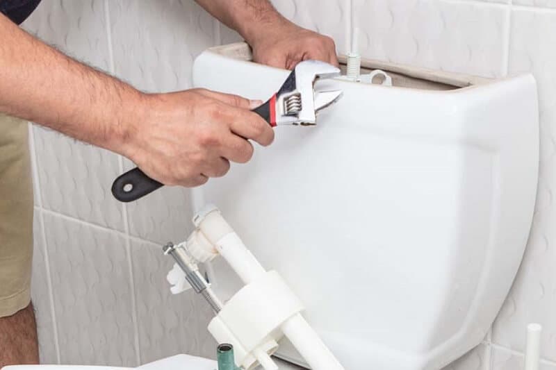 Toilet cistern components being inspected