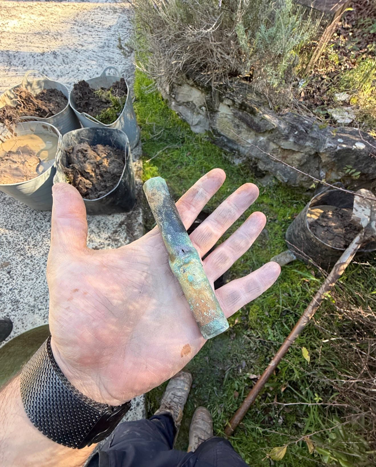 Removed copper pipe with a visible pinhole and surface corrosion