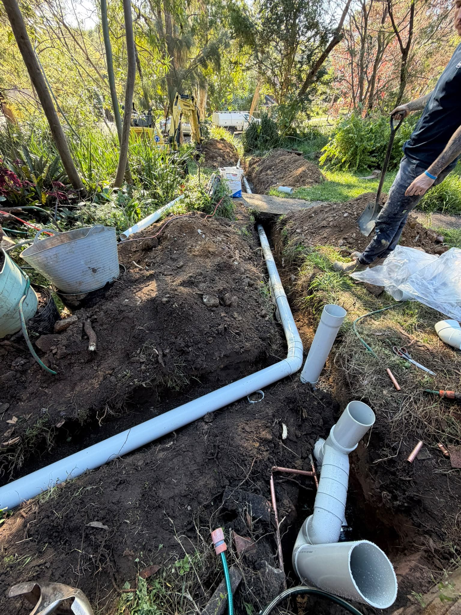 Drain pipework and junctions in a garden excavation