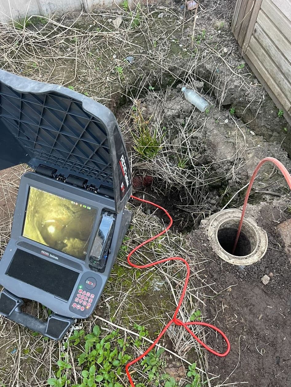 Drain inspection monitor and camera cable at an outdoor access point