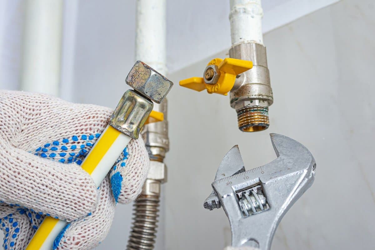 Gas fitter installing a gas appliance in a Normanhurst kitchen
