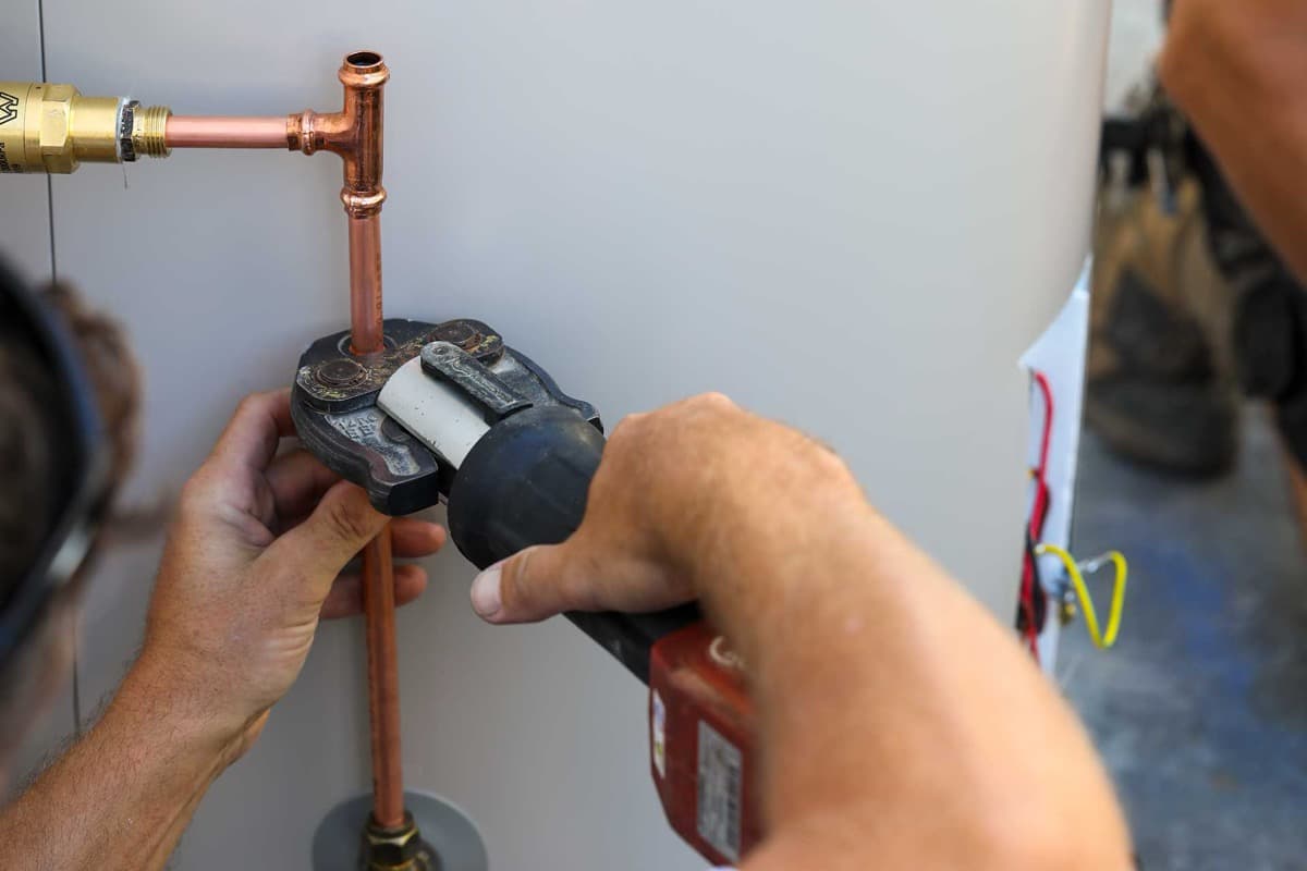plumber installing a new hot water system in Ashfield