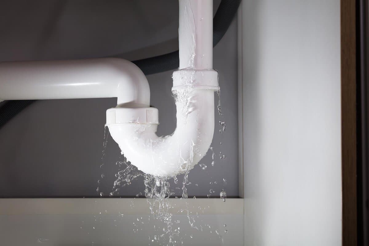 Plumber repairing a water leak in a Seven Hills home